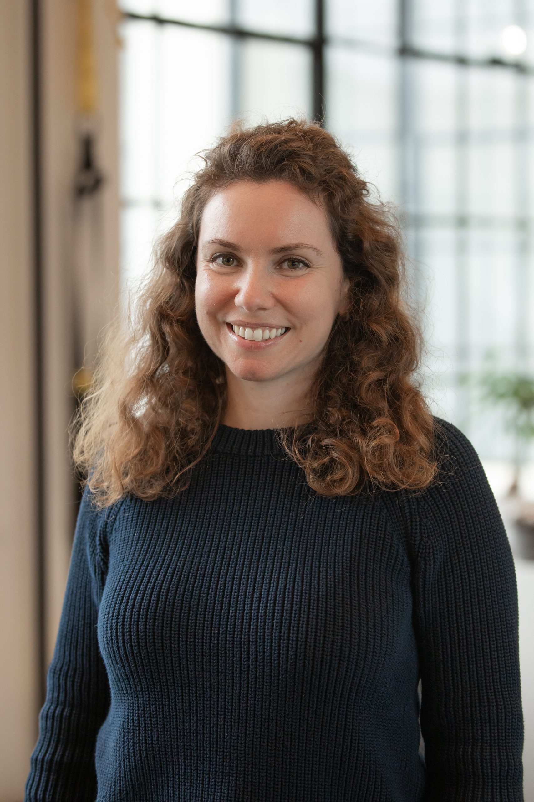 Portrait photo of Fiana Tulchinskaya PT, DPT, PCES. Blurred background.