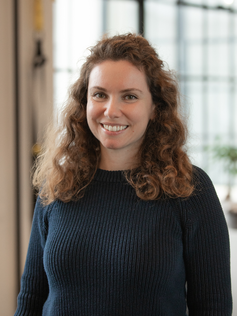 Portrait photo of Fiana Tulchinskaya PT, DPT, PCES. Blurred background.